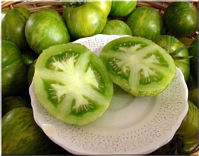 White plate with green tomato