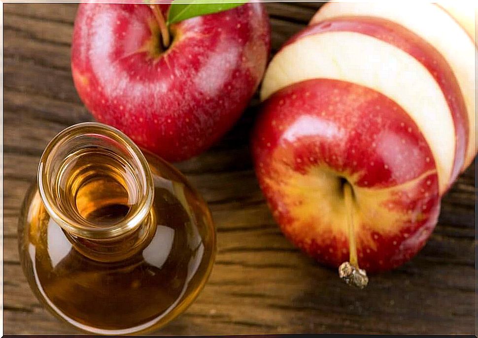 Apples and a bottle of vinegar