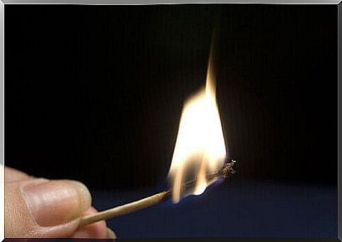 Burning match with black background