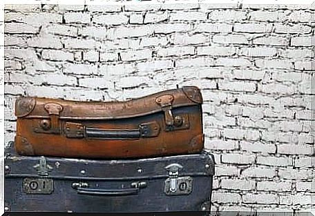 Old suitcases in front of a brick wall