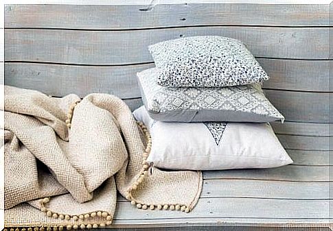 Decorative pillows on a wooden bench