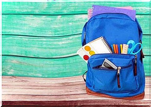 A blue backpack with school supplies in it