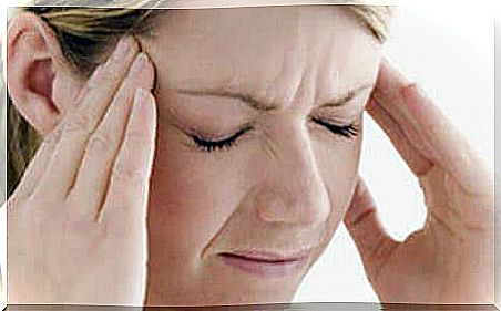 Woman massages her temples