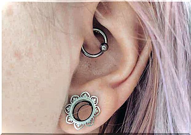 Woman with two types of ear piercings