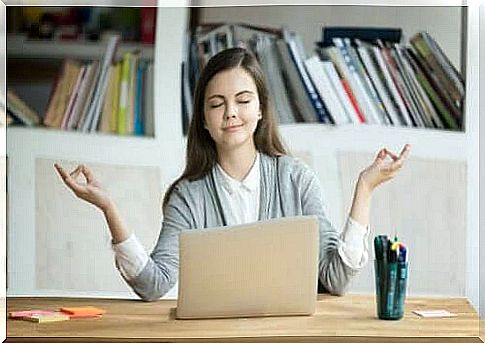 A woman is zen behind her computer