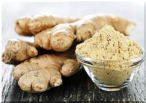 Ginger root with a bowl of ground ginger