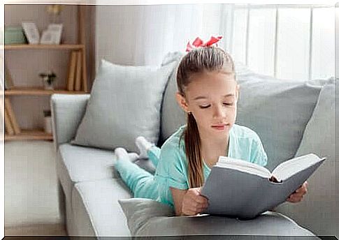 Girl is reading on the couch