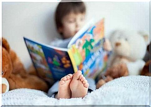 Boy sitting on bed reading