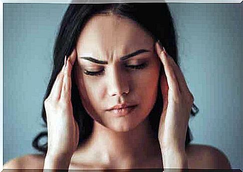 Woman massages her temples