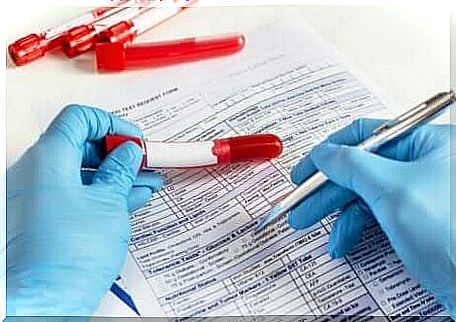 A doctor fills out a form for a blood test